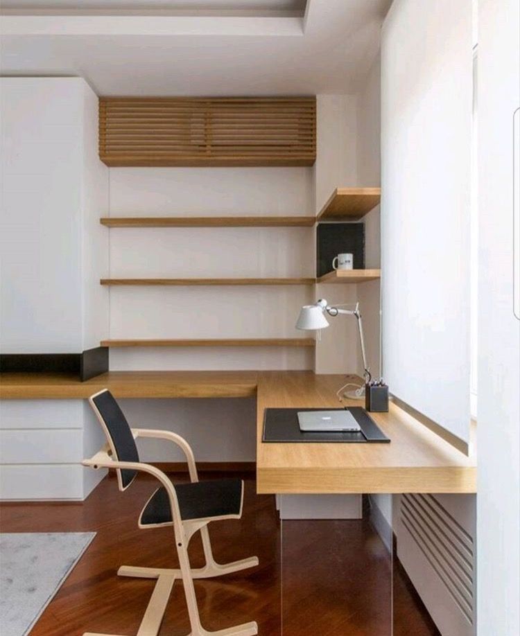A quiet corner desk with open shelving and soft daylight